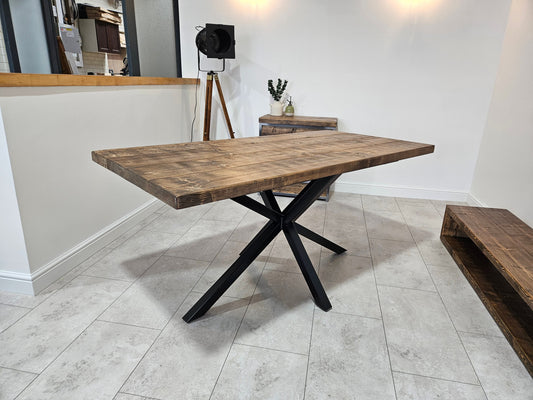 Industrial dining table with spider-style metal legs and wood top