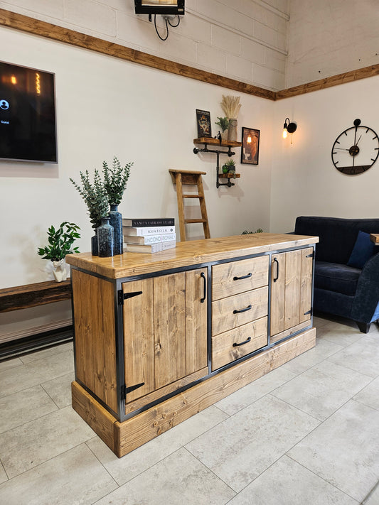 Wooden sideboard in a living room setting with decor elements.