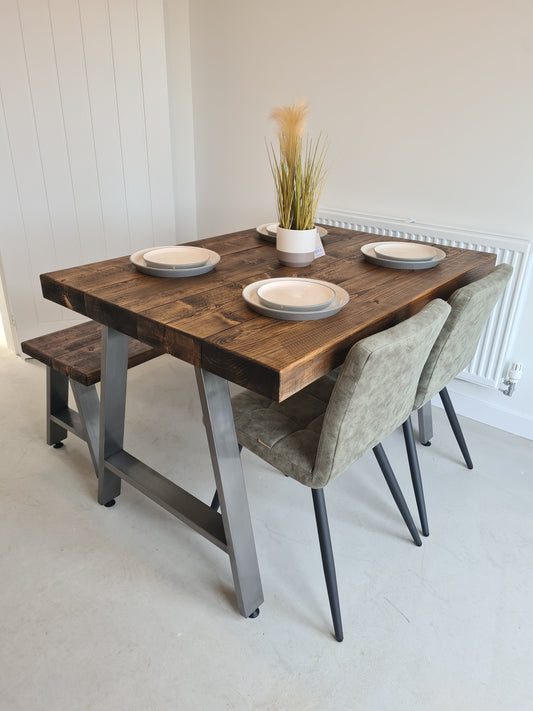Chunky industrial dining table with wood tabletop and A-frame metal legs